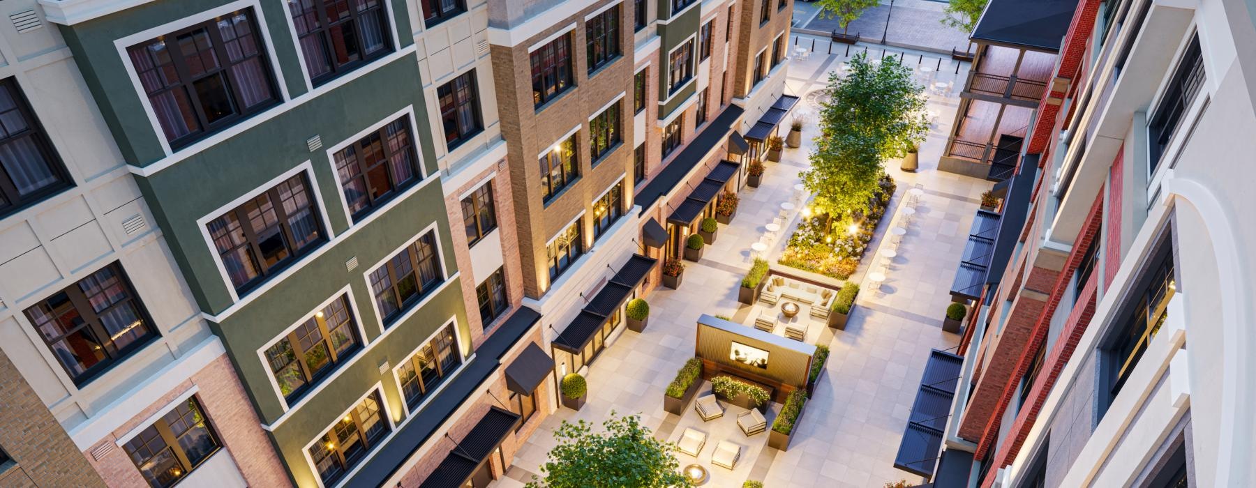 Settle into comfort at Courtside Flemington a courtyard with trees and buildings